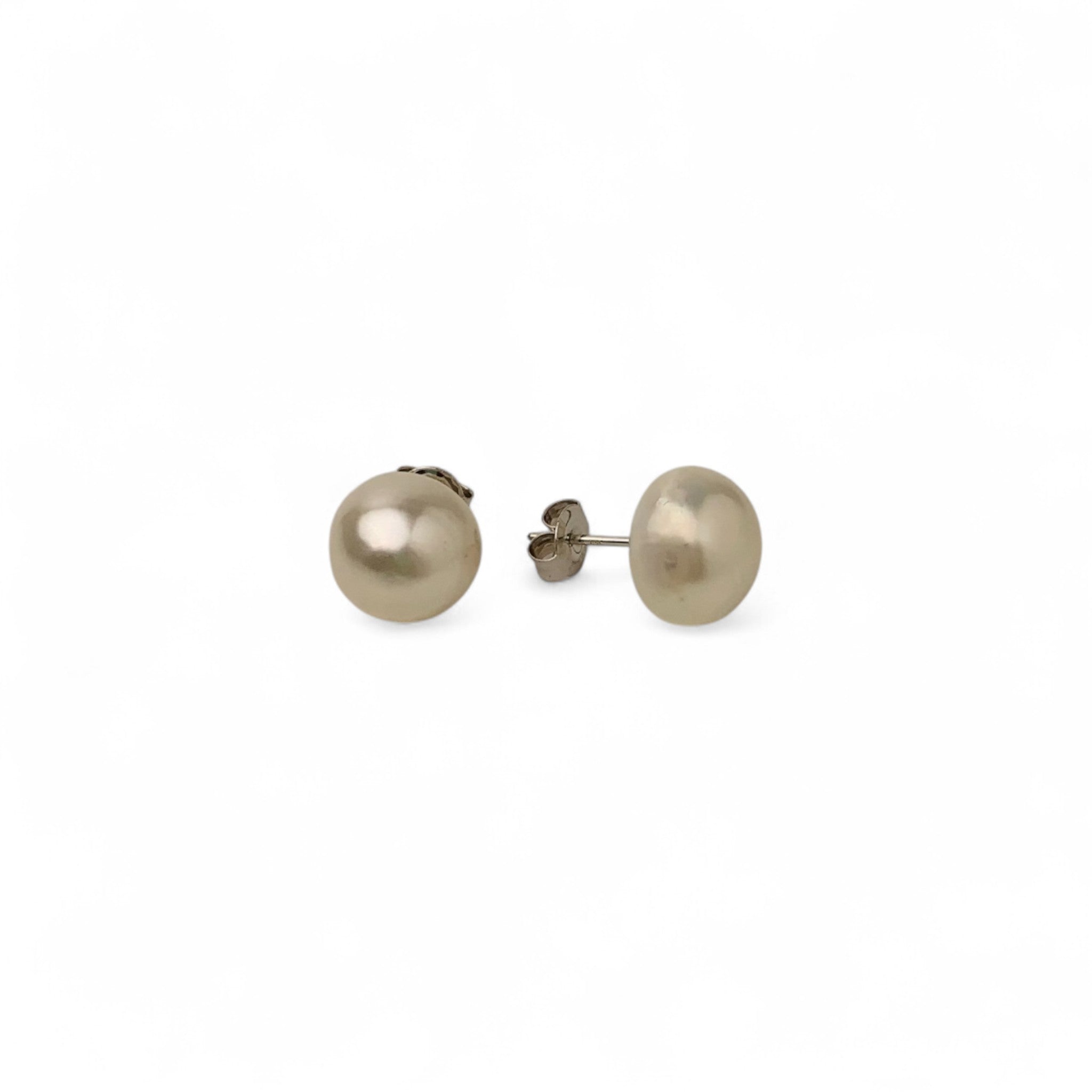 Pair of pearl stud earrings on a white background